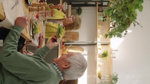 Elderly Man Putting Roasted Chicken Meat on Plates for Guests