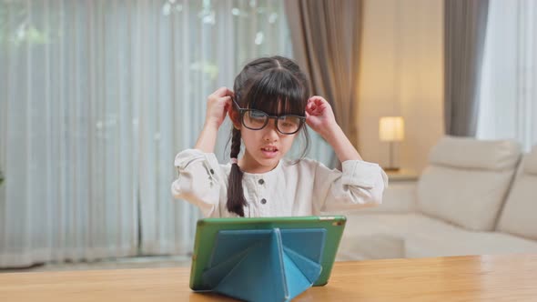 Young small girl kid student wear eye glasses to protect vision from digital screen for Healthy Eyes