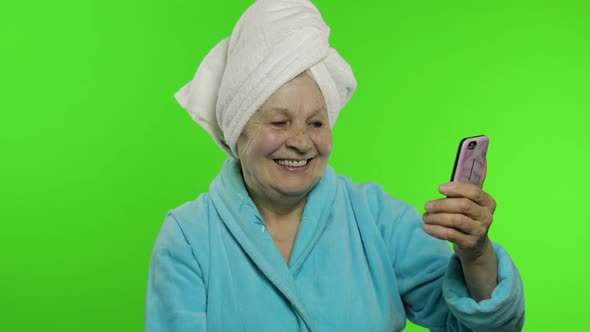 Elderly Grandmother After Shower. Old Woman Making Selfies Using Mobile Phone