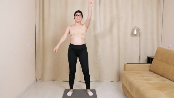 Young Woman in Glasses Doing Exercises Dancing