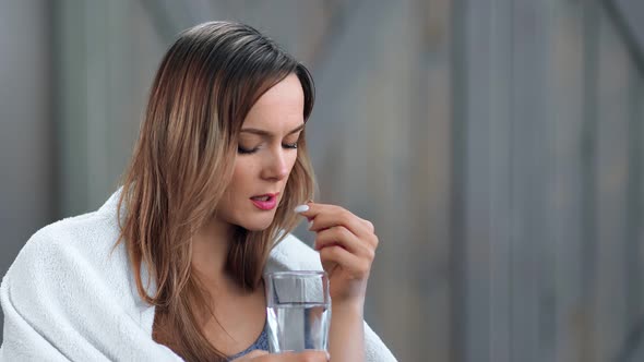 Unhealthy Young Woman with Flu Symptoms Drink Tablet with Water Close Up