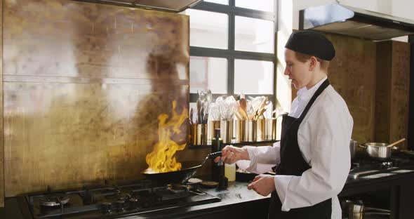 Chef cooking vegetables with fire