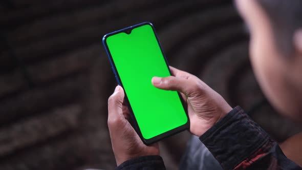 Close Up of Young Man Hand Using Smart Phone with Green Screen