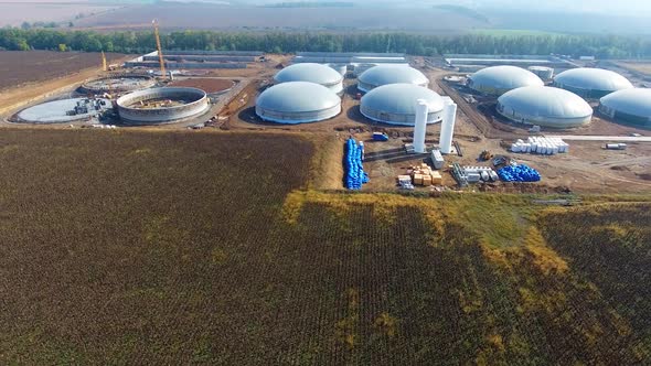 Construction of biogas plant on field. Large storage reservoirs for biogas production in environment