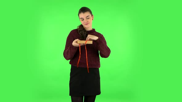 Girl Opens the Gift, Very Surprised and Gets Upset. Green Screen