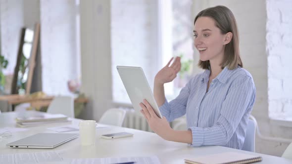 Cheerful Young Woman Doing Video Chat on Tablet