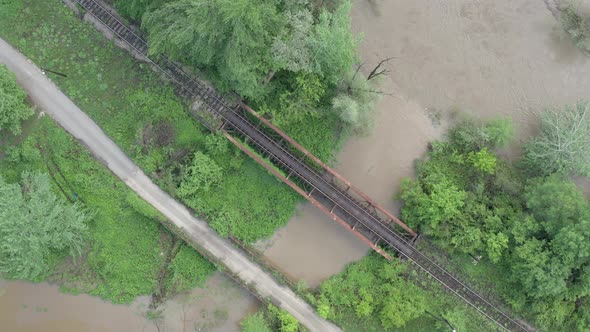 Road and railway bridge above the river from drone perspective 4K drone video