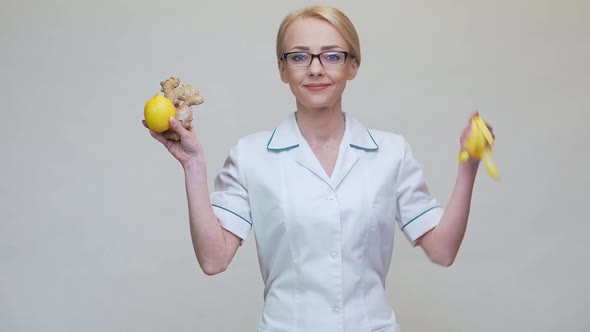 Nutritionist Doctor Healthy Lifestyle Concept - Holding Ginger Root, Lemon Fruit and Measuring Tape