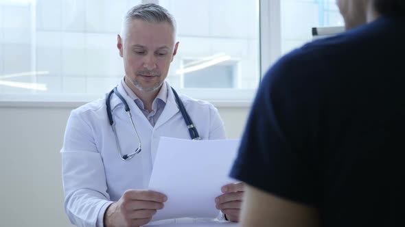Upset Doctor Discussing Medical Papers with Patient
