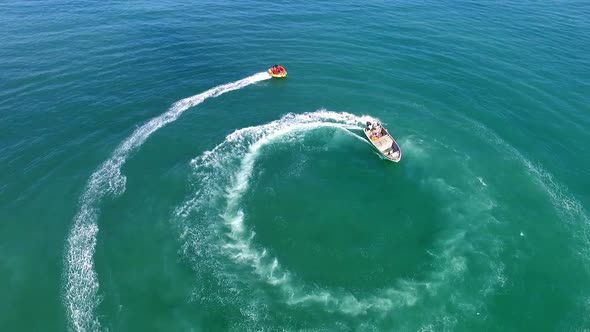 Motor Boat Stretching from a Boat in Circles