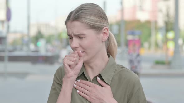 Unwell Woman Coughing while Standing Outdoor