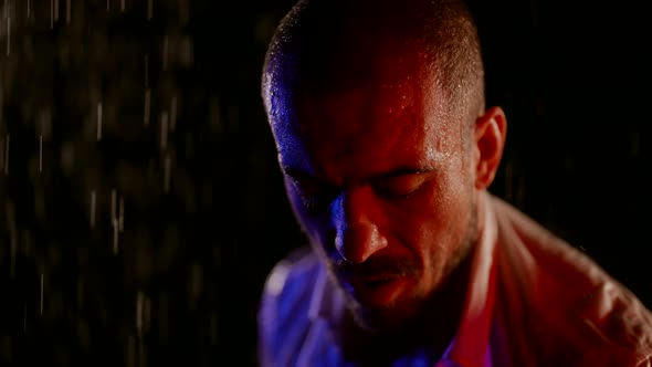 Exhausted Man in Rain in Night Closeup Portrait Shot Fighter After Fight or Run