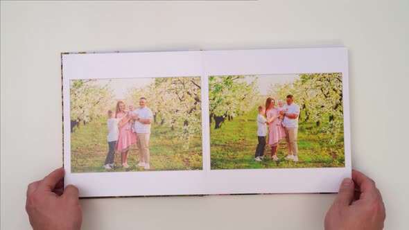 White Background Leaf Through Photobook From Family Photo Shoot in Spring Garden