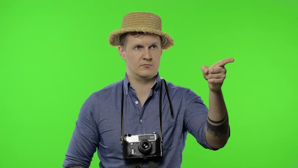 Portrait of Young Man Tourist Photographer Pointing Finger. Chroma Key