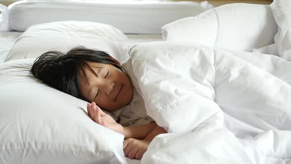 Cute Asian Child Sleeping  On White Bed Slow Motion