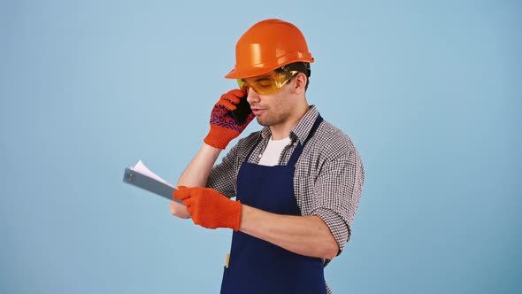Young Male in Safety Clothes Hard Hat Protective Goggles Gloves