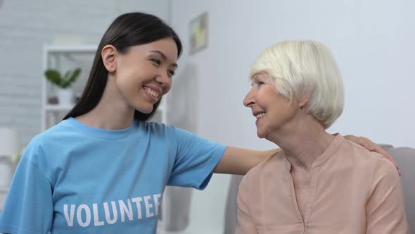 Female Activist Hugging Mature Woman Smiling Each Other, Social Volunteering