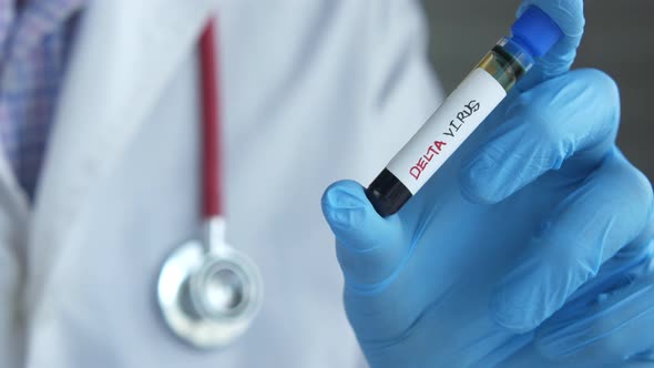 Hand in Latex Glove Holding Delta Corona Virus Blood Test Tube