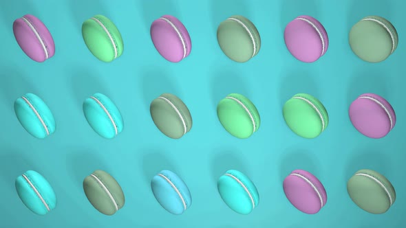 Multicolored macaron pastries on light turquoise paper background