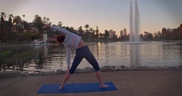 Woman Doing Yoga In The Park At Dawn