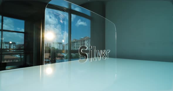 Glass Silver Letters and Office in Background