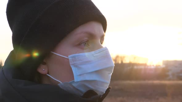 Portrait Of Young Woman Wearing Mask Outdoors. Coronavirus Concept.