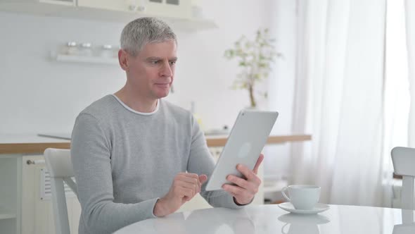 Senior Old Man Doing Video Chat on Tablet at Home