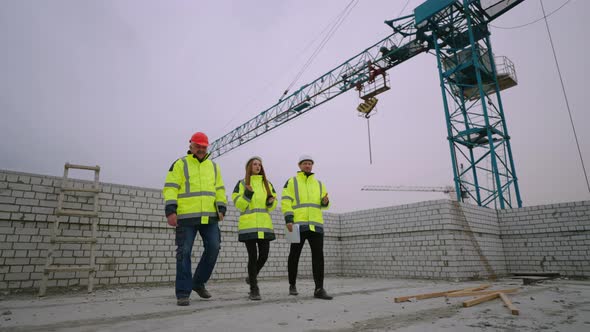 Group of Building Inspectors in Construction Site Female Architect and Male Civil Engineers