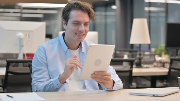 Man Making Video Call on Tablet in Office