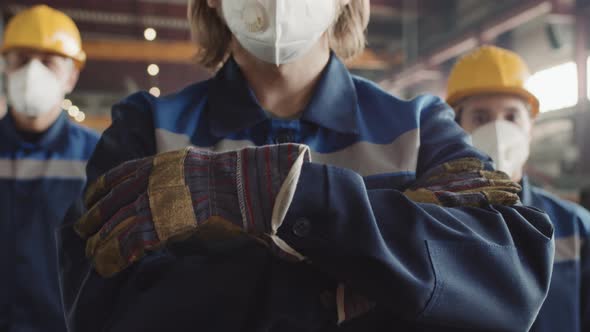 Close Up Of Plant Foreman With Workers In Respiratory Masks