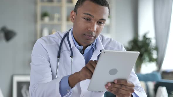 African-American Doctor Using Tablet for internet Browsing