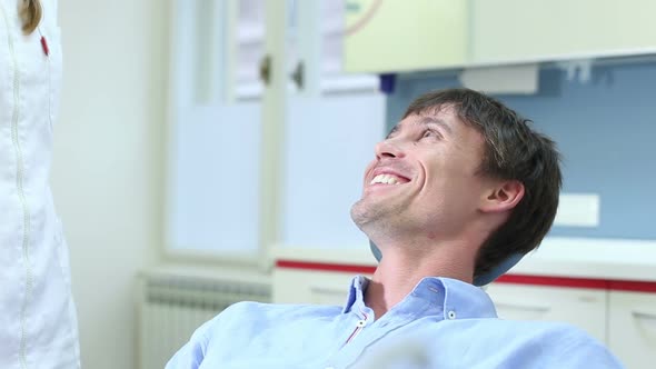 Close up of attractive man having dental examination of aching tooth