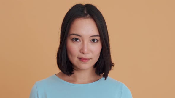 Happy woman in blue t-shirt looking at the camera