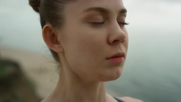 Closed Eyed Girl Meditating on Beach Close Up