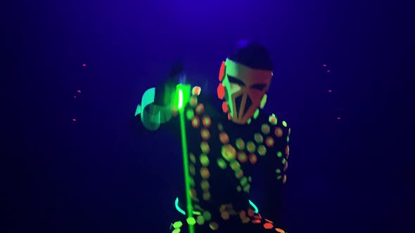 Animator Dances with Green Beams on Gloves at Nightclub