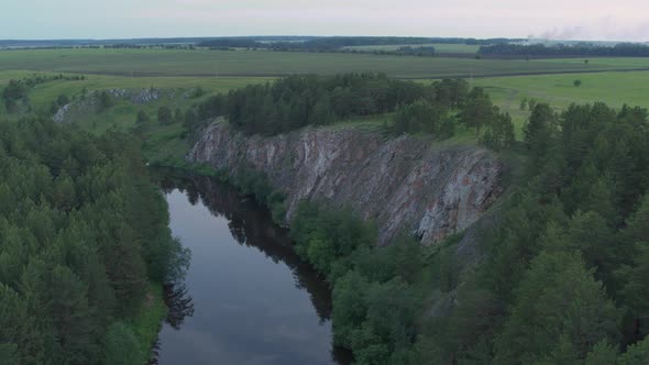 Aerial View of the River with Smooth Water and Forest on the Banks