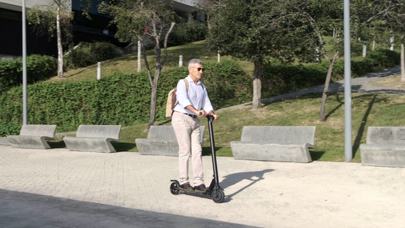 Senior man riding on electric scooter