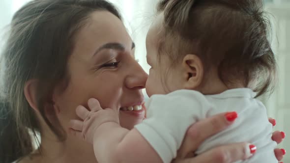 Mother Giving Baby Eskimo Kiss