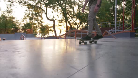 Skateboarder Doing a Tricks in a Concrete Skate Park
