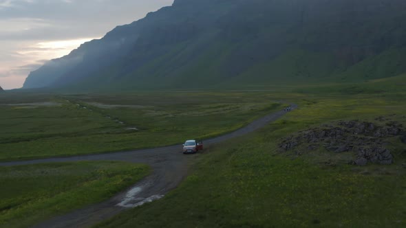 Birds Eye Orbit View of Four By Four Off Road Car Parked in Grassy Highland of Iceland