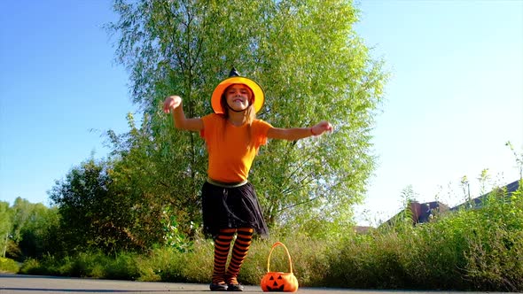 Child Girl in Costume Celebrates Halloween