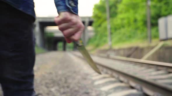 Maniac with a Knife Near the Railway Tracks.