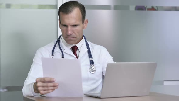 Doctor Working on Medical Documents in Clinic