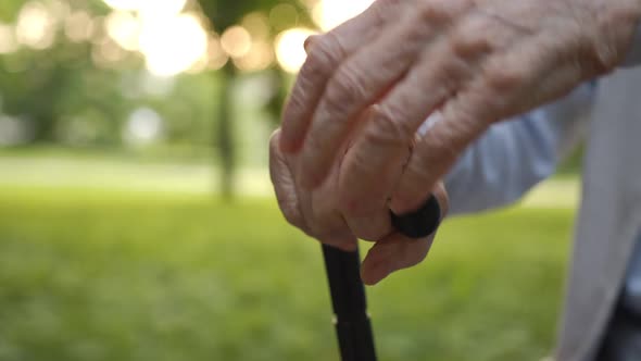 Upset Stressed Retired Older Man Holding Hands on Cane