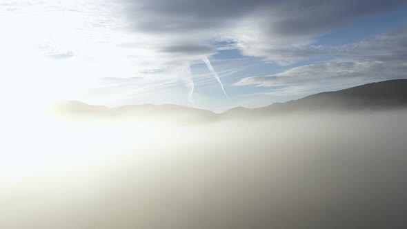 Flying Above the Clouds in a Misty Morning