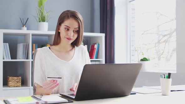 Young Woman Works at Home Office Using Computer.