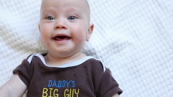 Caucasian Baby Portrait Grimacing Infant Looking to Camera Funny Face Emotions