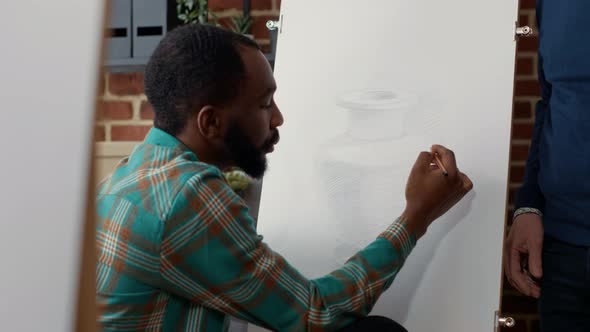 Young Man Drawing Inspiration Model on Canvas in Art Class