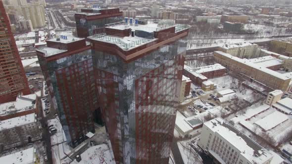 An aerial view of glossy modern buildings against the urban scenery