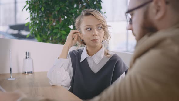 A Married Couple at the Manager's Desk Waiting for a Deal